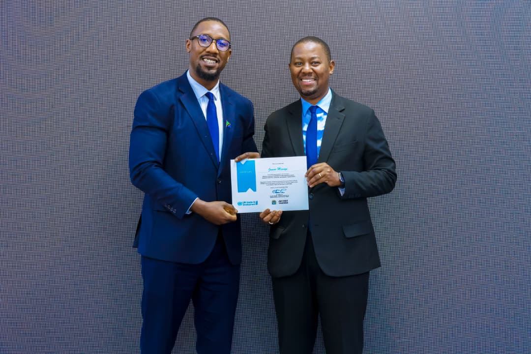 Junior Msangi receiving a certificate at an investment event
